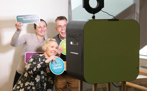 employees participating in a photo booth 
